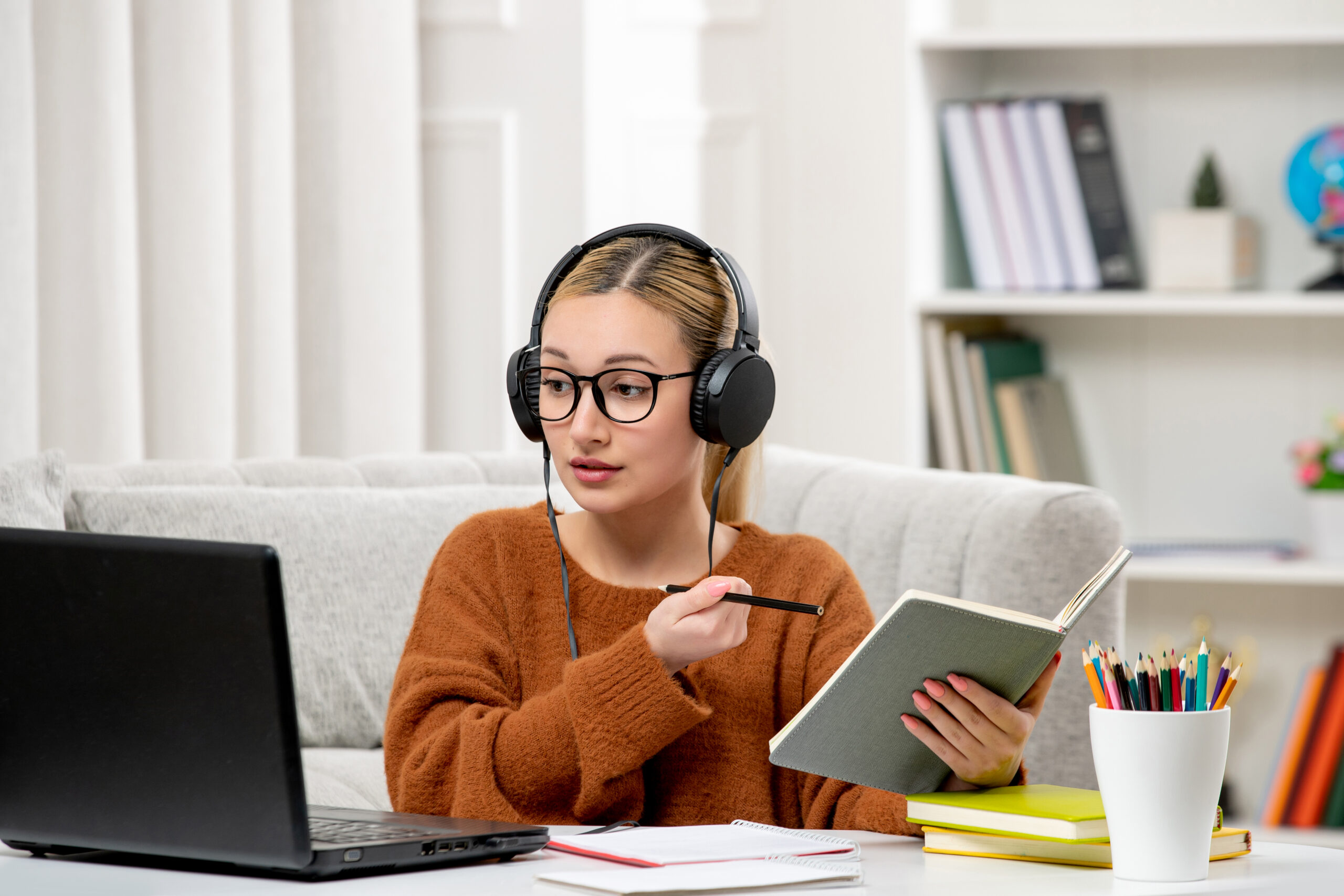 student online cute girl glasses sweater studying computer writing down notes